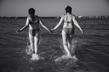 Mother and daughter having fun on the beach.