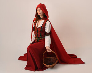 portrait pretty young female brunette model wearing a red hooded fairytale cloak and medieval...