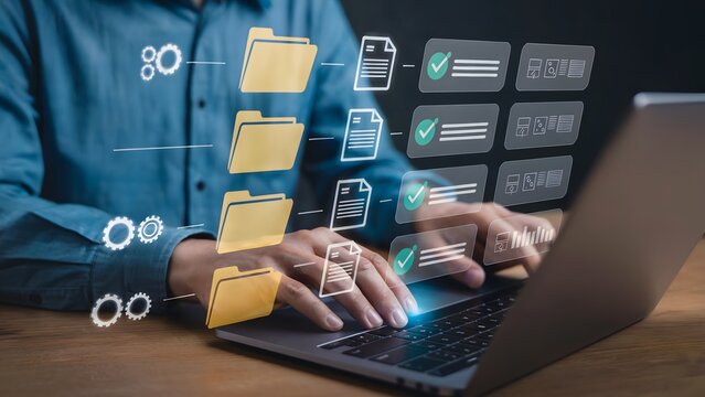 Person using laptop with digital file management icons and folders displayed above the keyboard area - Powered by Adobe