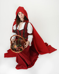 portrait pretty young female brunette model wearing a red hooded fairytale cloak and medieval...