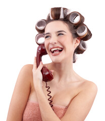 Happy woman with hair curlers, using a vintage telephone while look from the side. Concept of hairstyle, makeup, beauty routine, and cosmetics. Possibly Making a hair appointment. Isolated on white