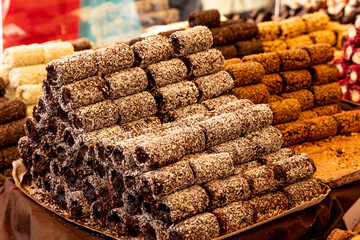 Stacked chocolate coconut pastries at a market