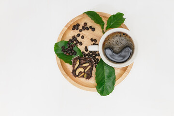 Hot black coffee cup and coffee beans,leaf on  wooden tray with white background.