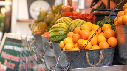 Fresh fruits and juice stand at street market offering colorful seasonal produce