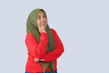 Muslim woman thinking with finger on chin in studio pose, ideal for concept of idea, planning,...