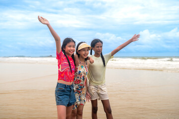 Young teen girls enjoy beach time together during summer holidays