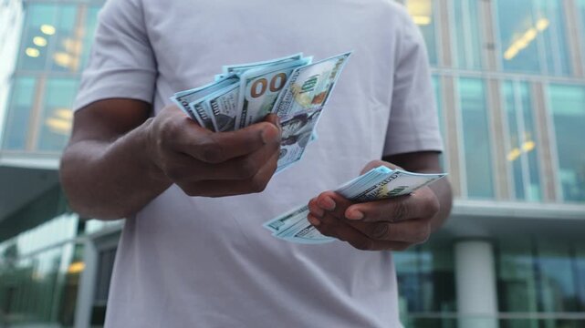 Man hands holding money dollar bills on urban street outdoor. Businessman hands counting currency money outdoors near office bank building. Unrecognizable man holding cash. Finance economy banking