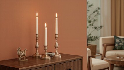 Detailed view of glowing candles alongside a small statue on a cabinet next to a wall in a sitting room