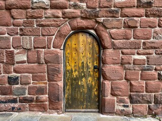 old wooden door with stone wall