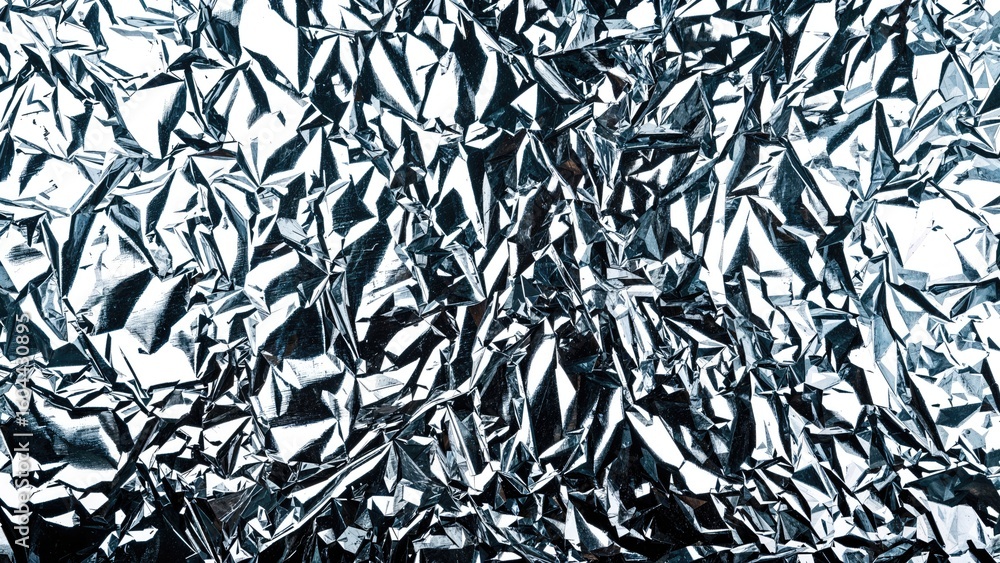Poster macro image capturing the rough surface of reflective metallic crepe paper or foil, abstract backgro