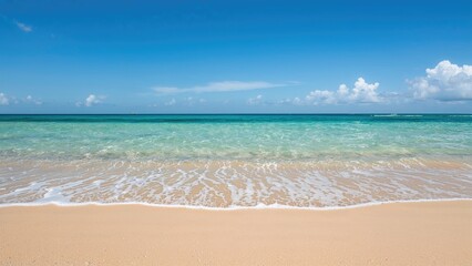 Fototapeta premium An idyllic beach scene with soft sand, peaceful ocean waves, and a clear sky, showcasing natural beauty for a summer vacation.