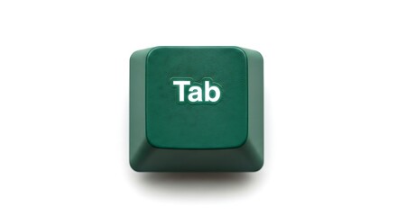 Close up of a green Tab key on a white background