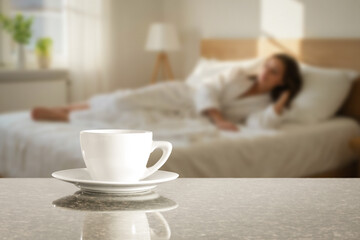 Morning coffee on stone table with copy space in cozy bedroom. Blurred woman in bed in sunlit bedroom background, peaceful morning atmosphere. Concept of breakfast in bed, relaxation, lifestyle.