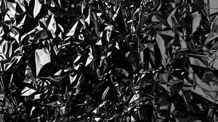 Silver and black foil featuring a glossy finish with a crinkled, coarse texture on a monochrome backdrop