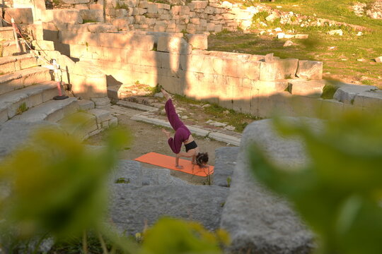 Girl doing yoga in ancient theater
