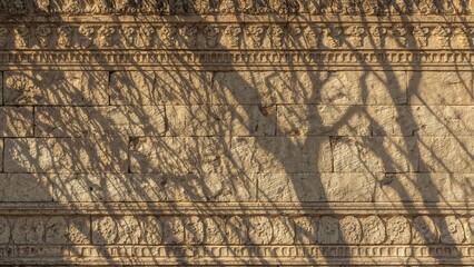 Sculpting a wall made of sandstone bricks