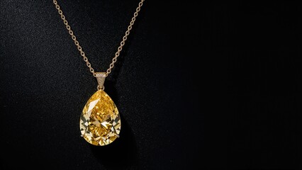 Black background highlighting a yellow pear-shaped diamond necklace