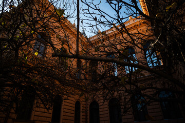 Baroque style Patriarchal Palace in Sremski Karlovci, Serbia, seen through bare autumn trees. Warm...
