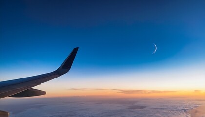 view of a thin sliver of moon in the sky from plane window