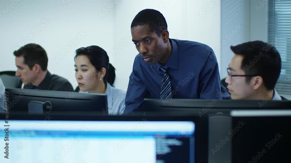 Aufkleber a diverse group intently reviews data on monitors in an office setting