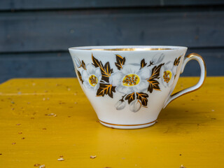 Fine porcelain tea or coffee cup with floral motif. Vintage tableware collection. Time for a break