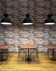 Comfortable library setting with wooden tables and modern chairs against a brick wall