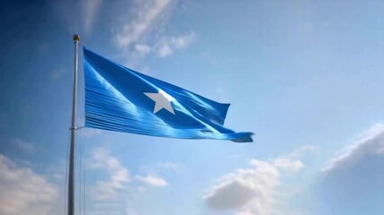 The flag of Somalia is prominently displayed, fluttering in a gentle breeze against a vibrant blue sky and soft clouds, symbolizing national pride.