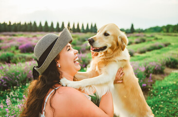 woman with golden retriever on a lavender field