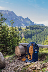 Backpack resting on a mountain bench with scenic view