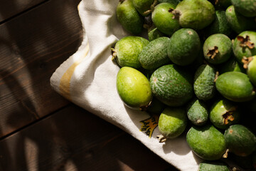 Fresh feijoas gathered on cloth display in natural light for autumn harvest celebration