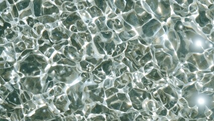 Textured surface of rippling water with sunlight reflections creating shimmering patterns in a natural aquatic environment