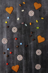 Various sweet food on black chalkboard background. Flat lay. Top view. Food concept.