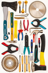 Flat lay of new and used hand tools on white background. Large collection of various tools and bits arranged on white.