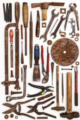 Flat lay of old hand tools on white background. Large collection of various rusty tools and bits arranged on white.