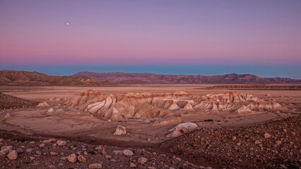 Fototapeta premium Panoramic view of Death Valley landscape in Atacama Desert showcasing unique rock formations under twilight sky with soft pastel colors