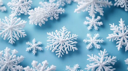 White snowflakes decoration lying on blue background creating winter atmosphere