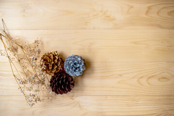 
Pine cone with dry grass flower on wooden background for Christmas decorative.
