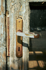 Rusty old door handle with a keyhole