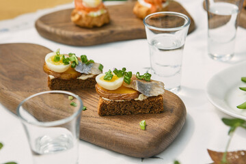 Potato, herring, and egg toast on rye with scallion, bright natural lighting, overhead serving...