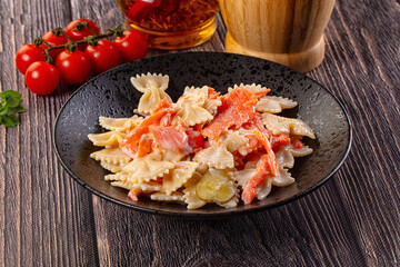 Italian pasta farfalle with salmon