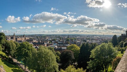 Scenic panorama capturing green gardens leading to old town structures in summertime