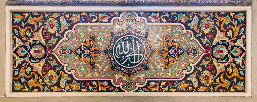 Juma Mosque in Baku, Azerbaijan, adorned with intricate floral motifs that enhance the spiritual ambiance. A captivating Arabic calligraphy mediating the structure, translates to: God is the greatest