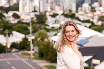 happy natural 24 year old woman on a suburban street