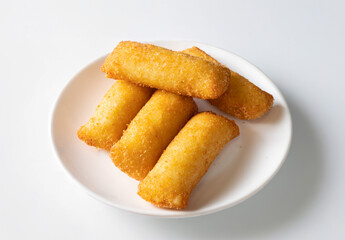 Crispy fried cheese croquettes isolated on a white background, made with melted cheese and breadcrumbs. Natural light highlights this popular junk food, perfect for fast food and street food lovers.

