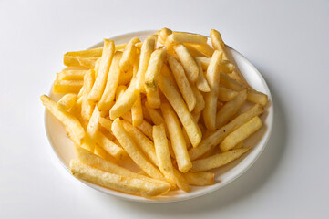 Crispy golden French fries isolated on a white background, showcasing fried potatoes. Natural light highlights this popular junk food, perfect for fast food and street food enthusiasts.

