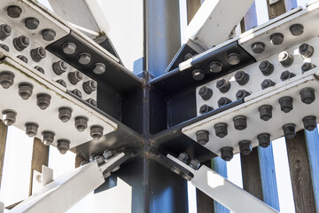 Heavy duty steel beam cross joint with bolts, close up view of industrial structure