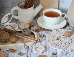 Decorative watering can flower pot crochet hooks collection table different handmade objects on the...