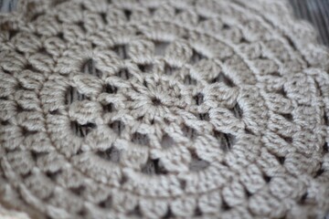 Crocheted mandala on wooden table background hobby handmade decor 