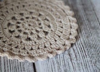 Crocheted mandala on wooden table background hobby handmade decor 