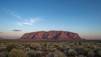 Sunrise Over a Rugged Peak in a Desert Landscape